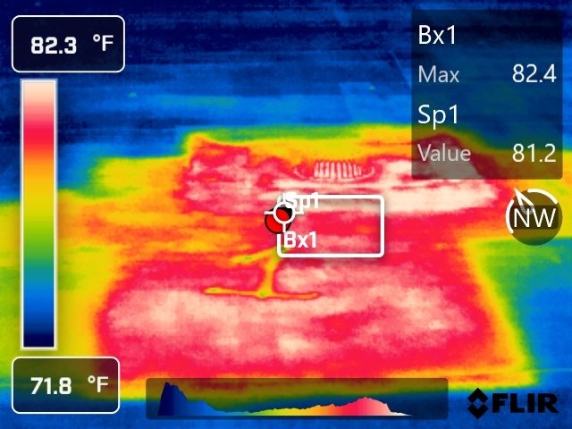 Infrared image of a commercial roof: a warm wet area boxed against cooler dry roof