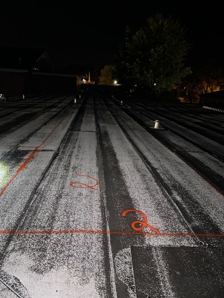 Photo of the same roof area, wet sections outlined in paint